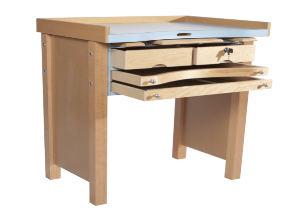 The MO-40 Jeweler’s Workbench is a thoughtfully designed, compact workbench tailored for jewelers who require a reliable, space-efficient setup, especially when working with a torch. The bench features a robust Formica laminated top, offering excellent heat resistance and protection for prolonged torch use, ensuring your workspace remains safe and durable.