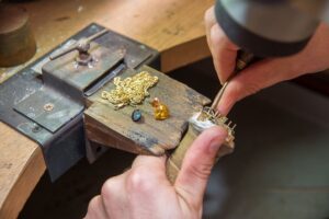 Jeweler using the bench pin on a jeweler's workbench.